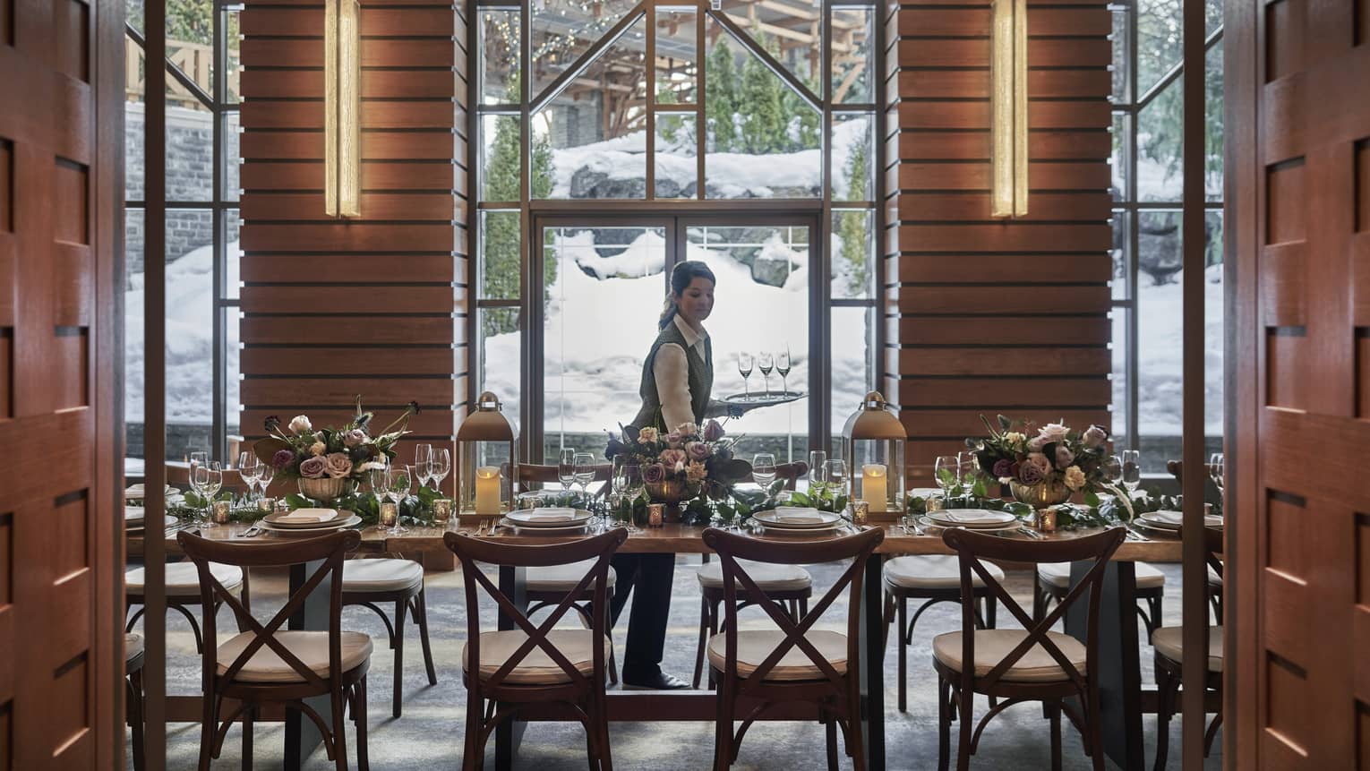 Hotel staff sets dining tables in Harmony Foyer event room