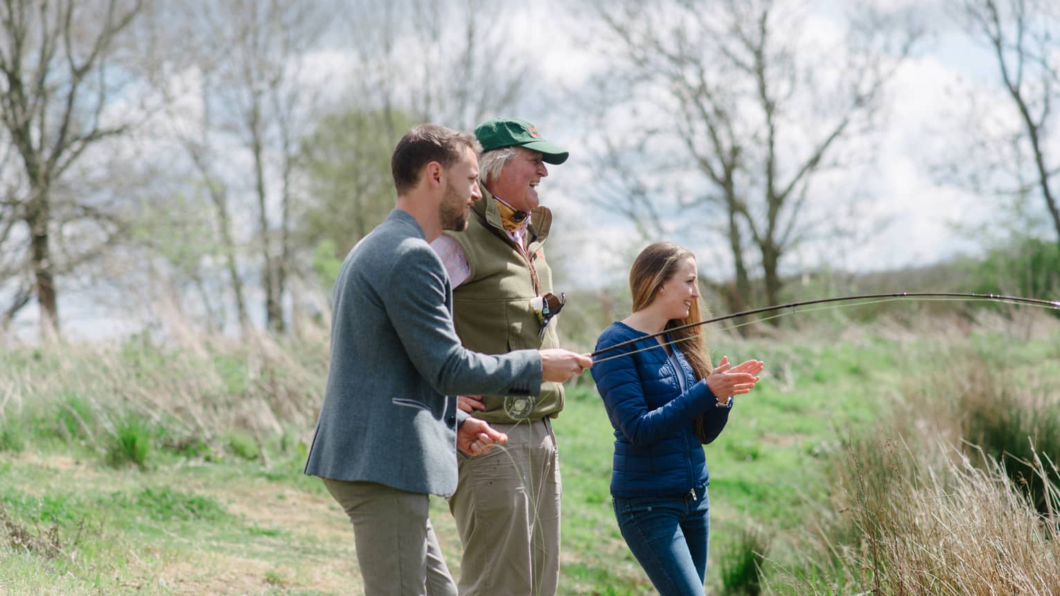 Couple fly fishing with an instructor