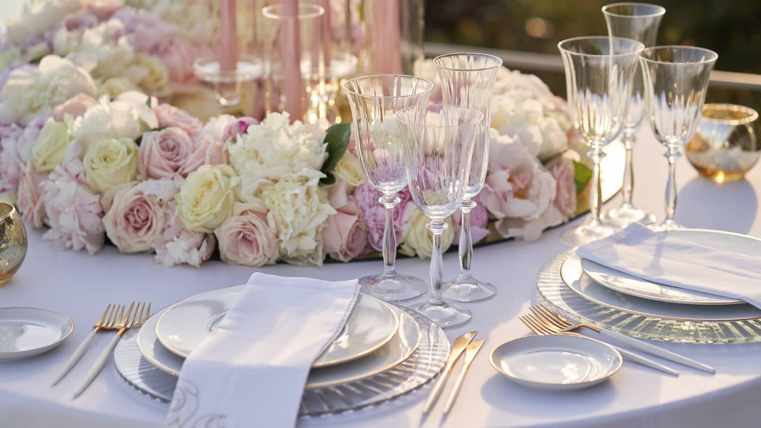 Elegant wedding table place setting with white and pink roses at Club Dauphin