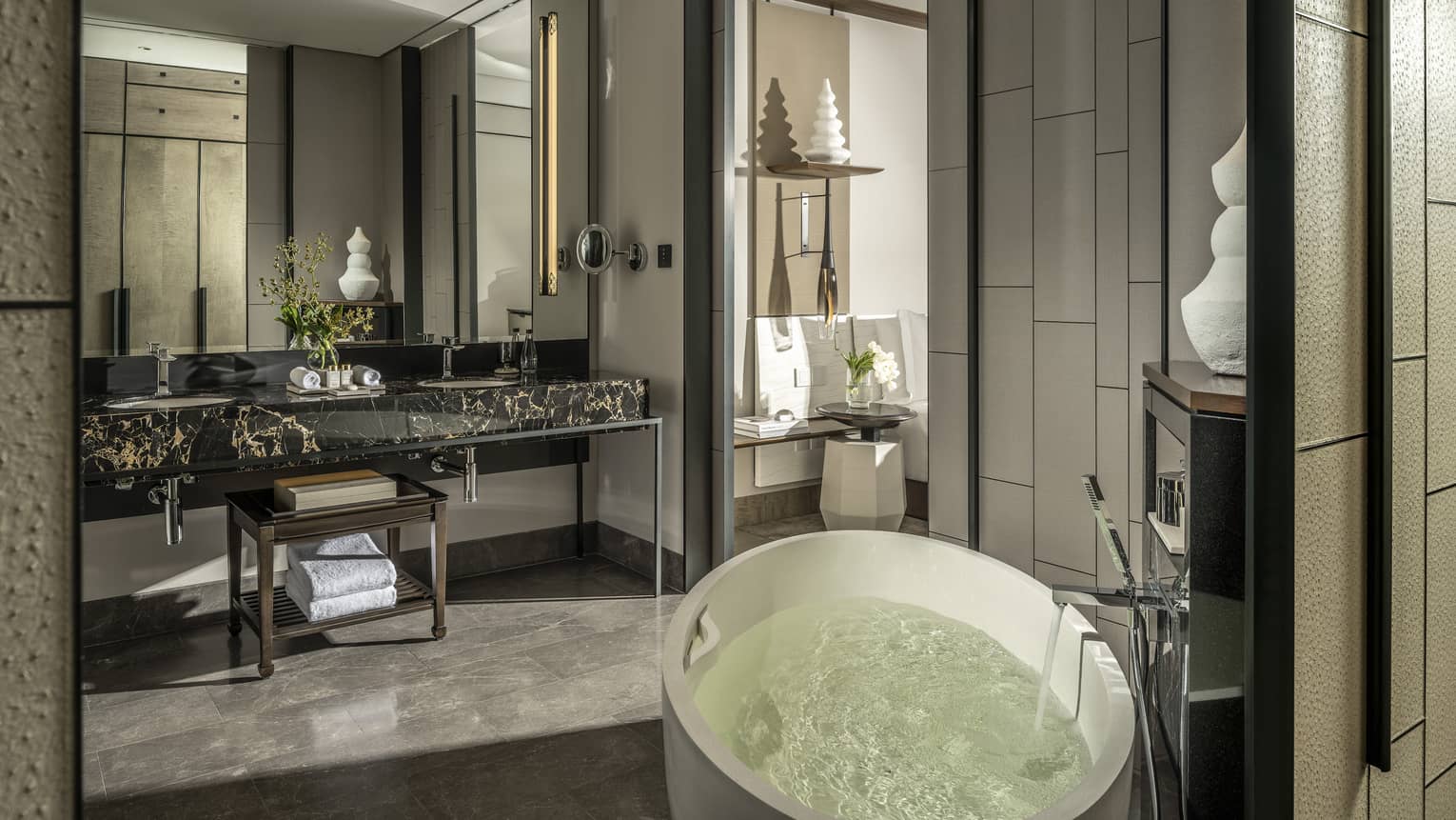 Guest bathroom, large mirror, standalone white tub, opening to bedroom