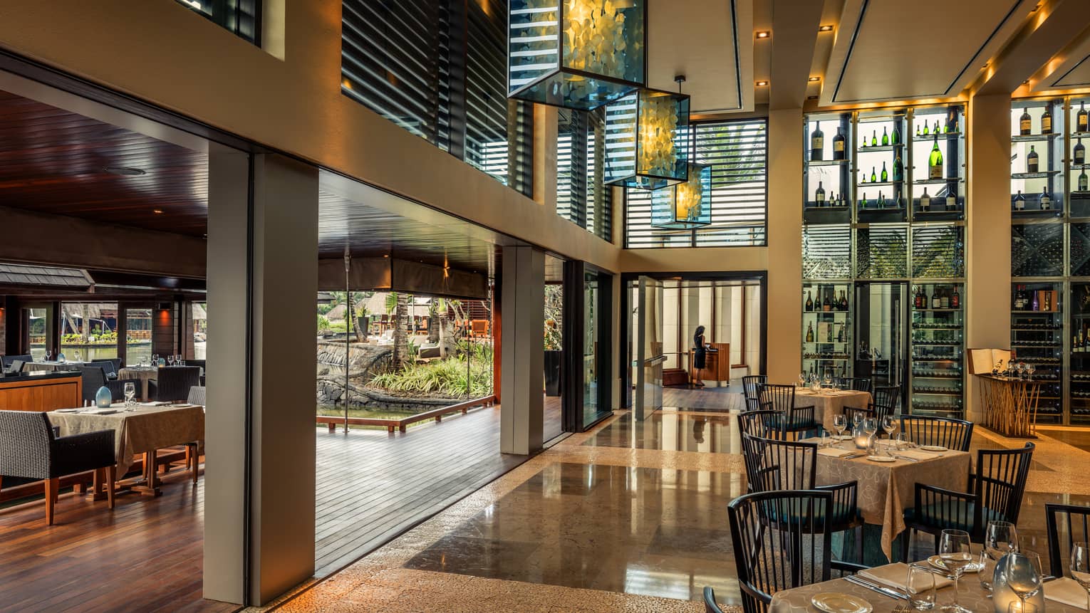 Beau Champ dining room with modern beams, glass lantern chandeliers