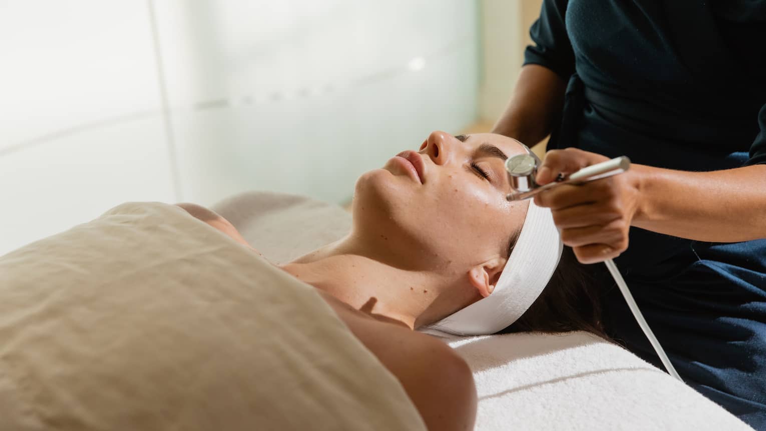 A woman gets a facial in luxury spa