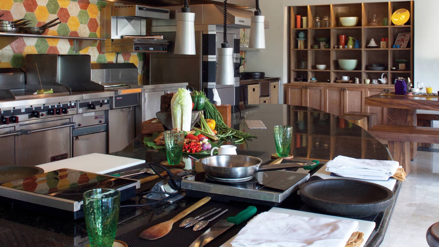 Jala Cooking Academy class station, table with hot plates, pans near stoves