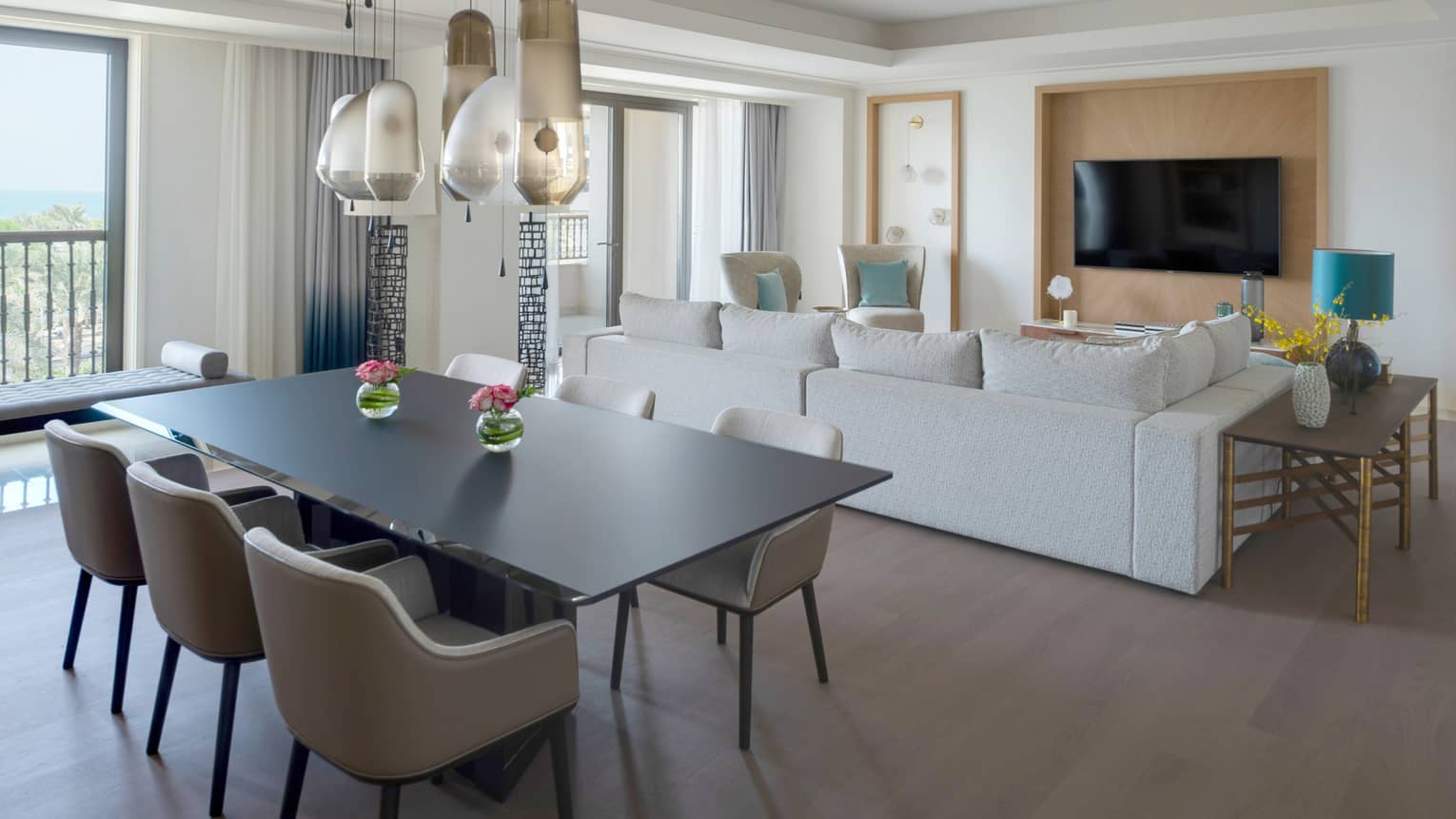 Black dining table with six chairs, abstract hanging light, living room