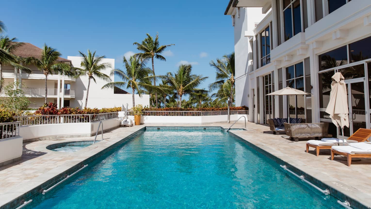 Outdoor resort pool with palm trees at Four Seasons Resort Oahu at Ko Olina