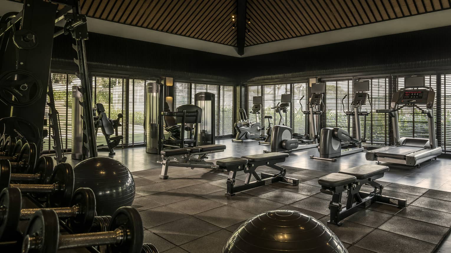 A spacious fitness centre with various exercise equipment.