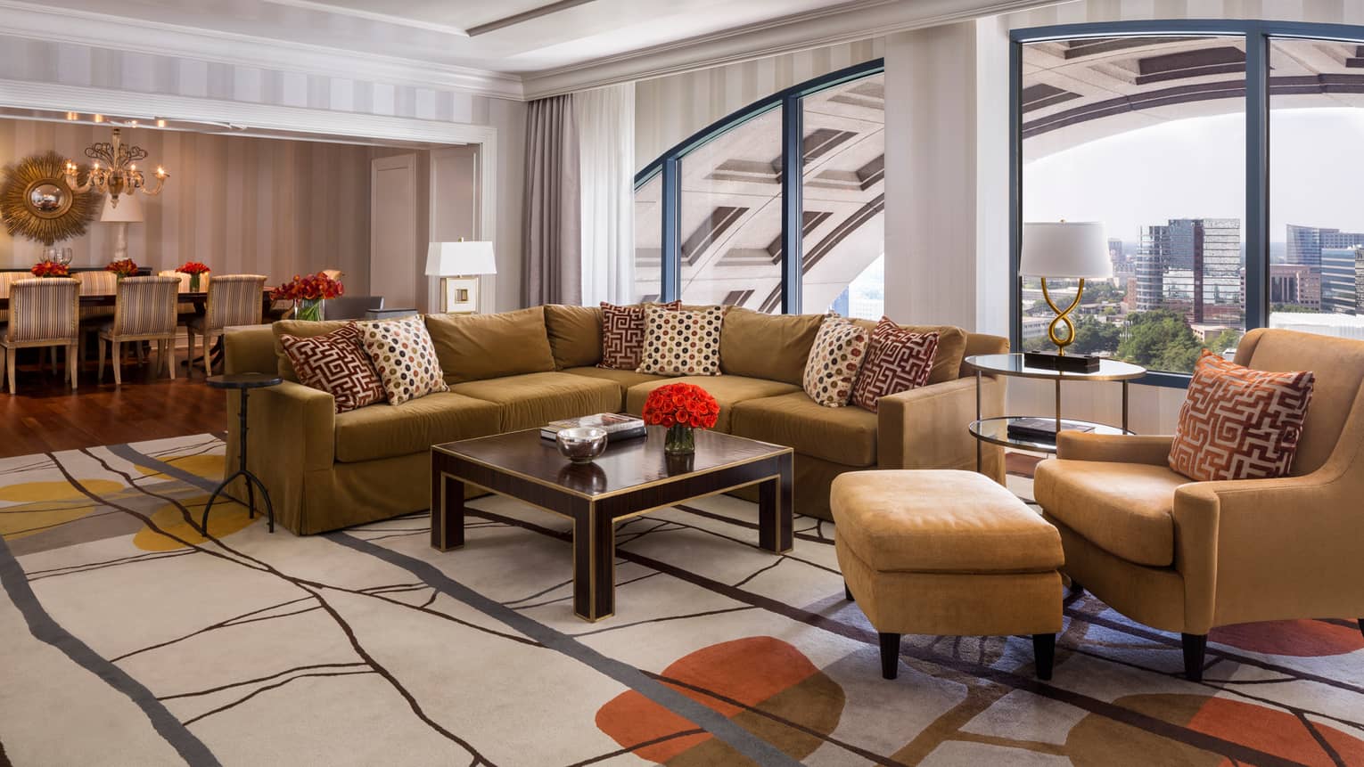 Presidential Suite gold L-shaped sofa, armchairs, dining room by large picture window