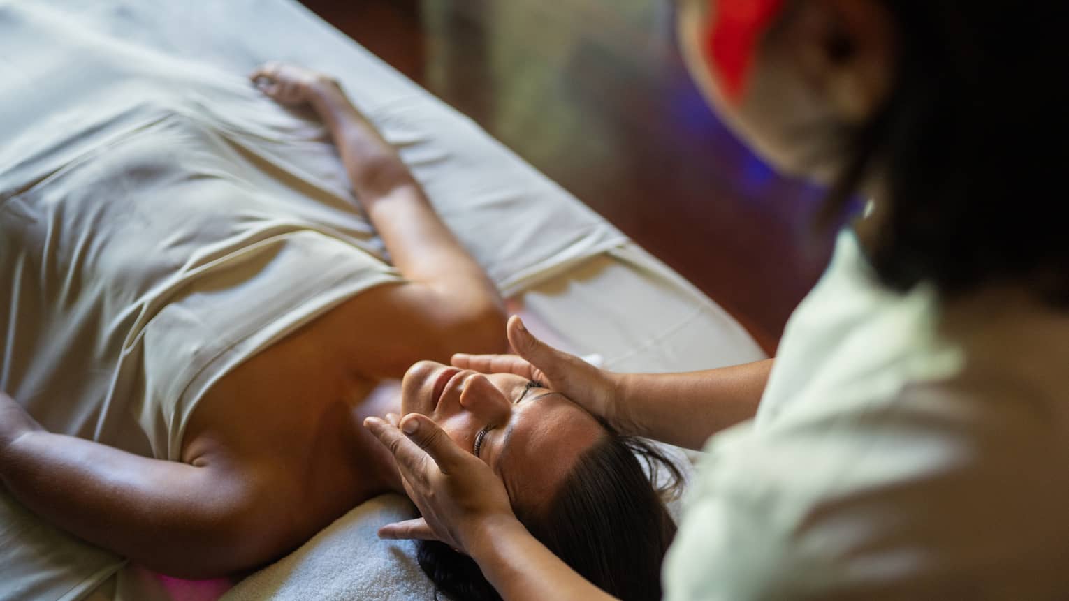 Female guest enjoys a facial at Te Mahana Spa