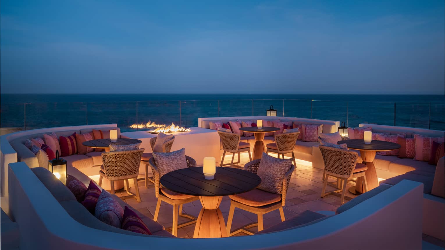 Rooftop bar overlooking the ocean at dusk