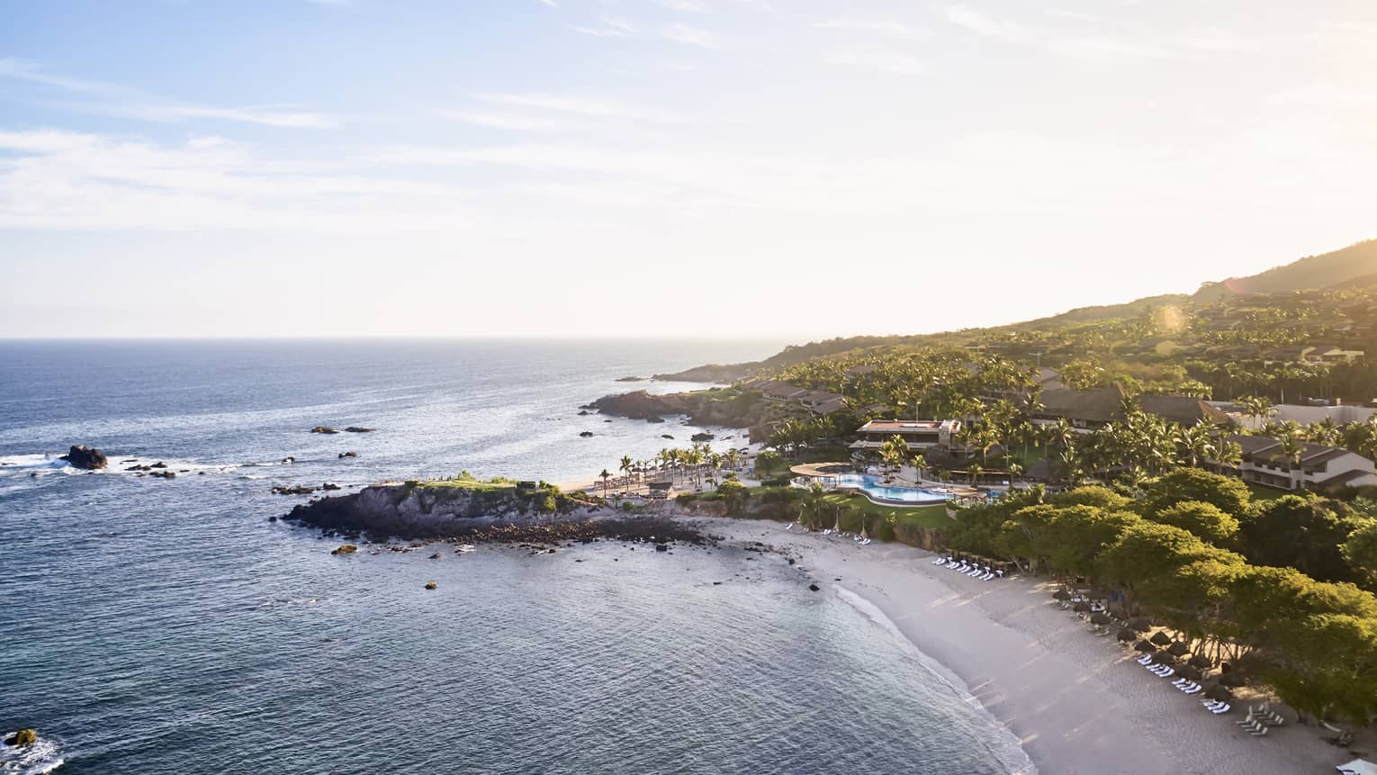 Sweeping aerial view of Four Seasons Resort Punta Mita coastline, beach and mountains