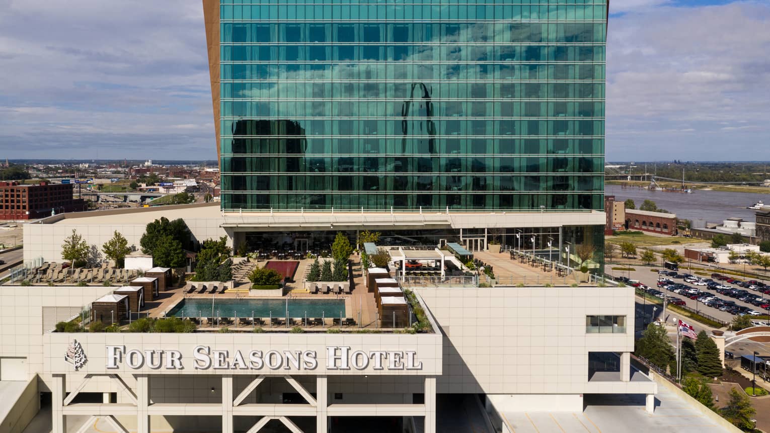 An aerial view of the rooftop of four seasons hotel saint louis, in front of a blue and orange skyscraper