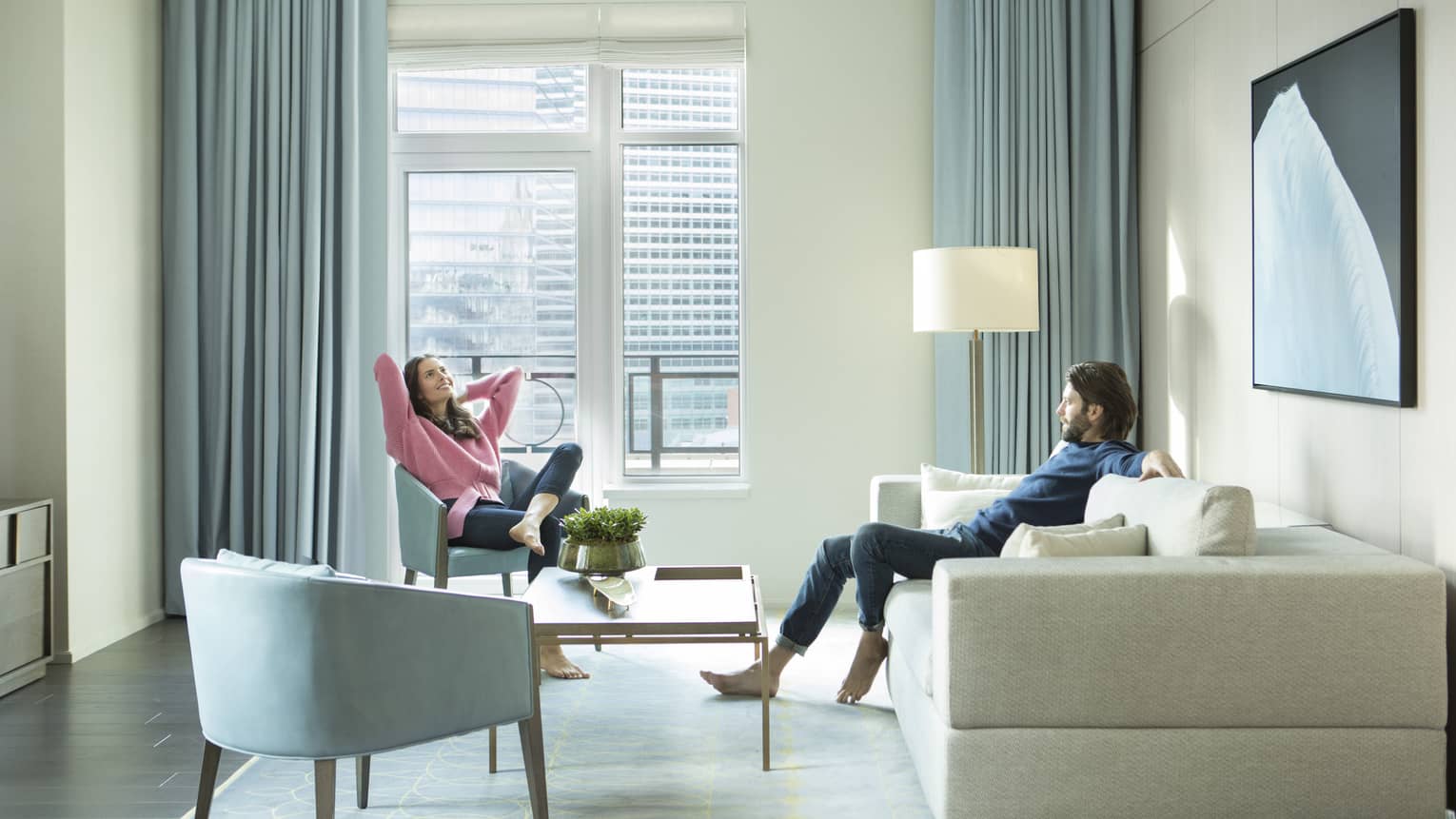Man and woman relax in guest suite 