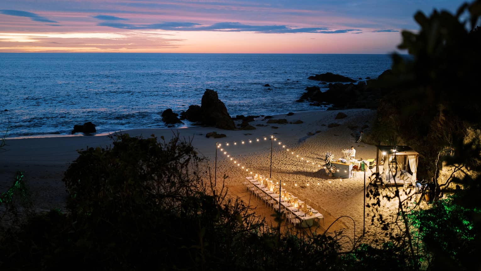 Aerial view of group dinner setup at dusk