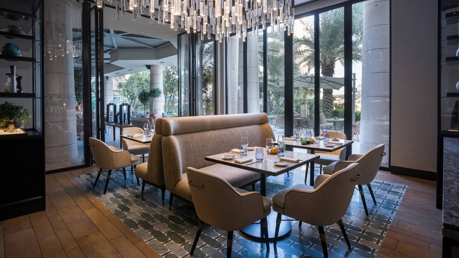 Dining room with floor-to-ceiling windows and a large crystal chandelier