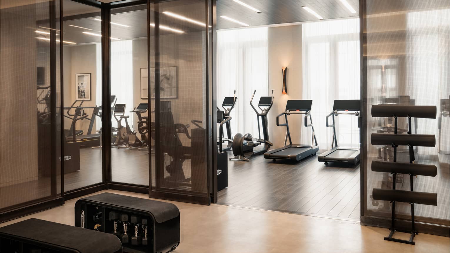 A Fitness Centre with exercise machines along the wall facing the windows