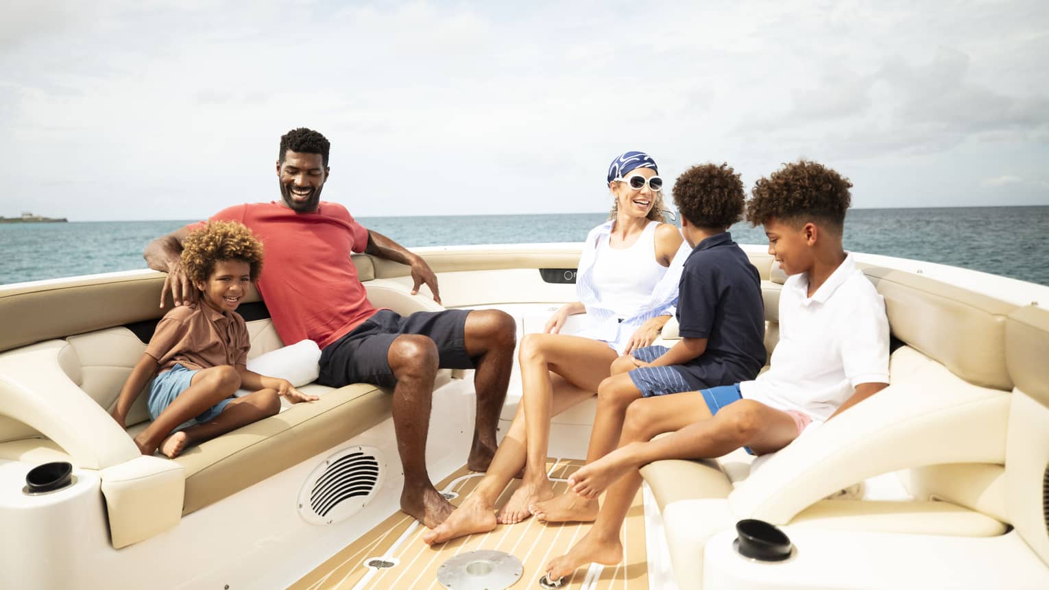 A family sits on a luxury boat on the ocean