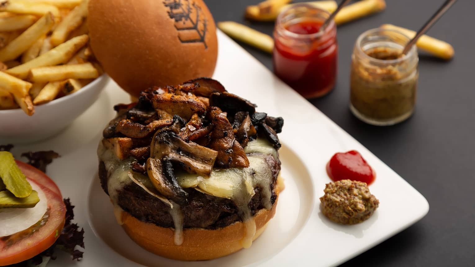 Ranger’s valley Australian beef burger, sautéed mushrooms, comté or brie cheese with side of French fries and condiments