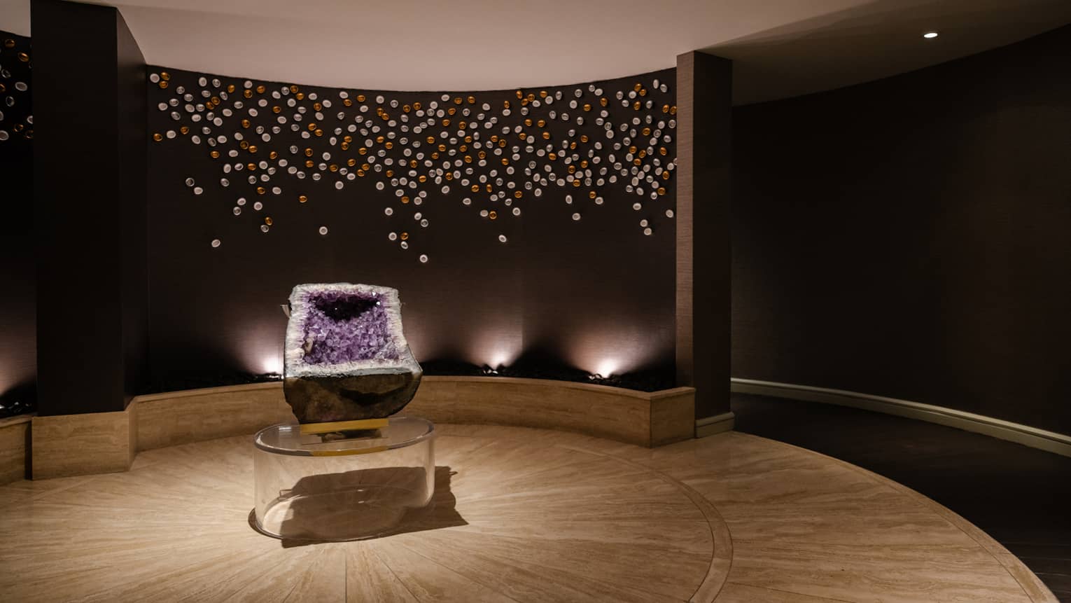 Spa room with a large purple stone and lights in the background