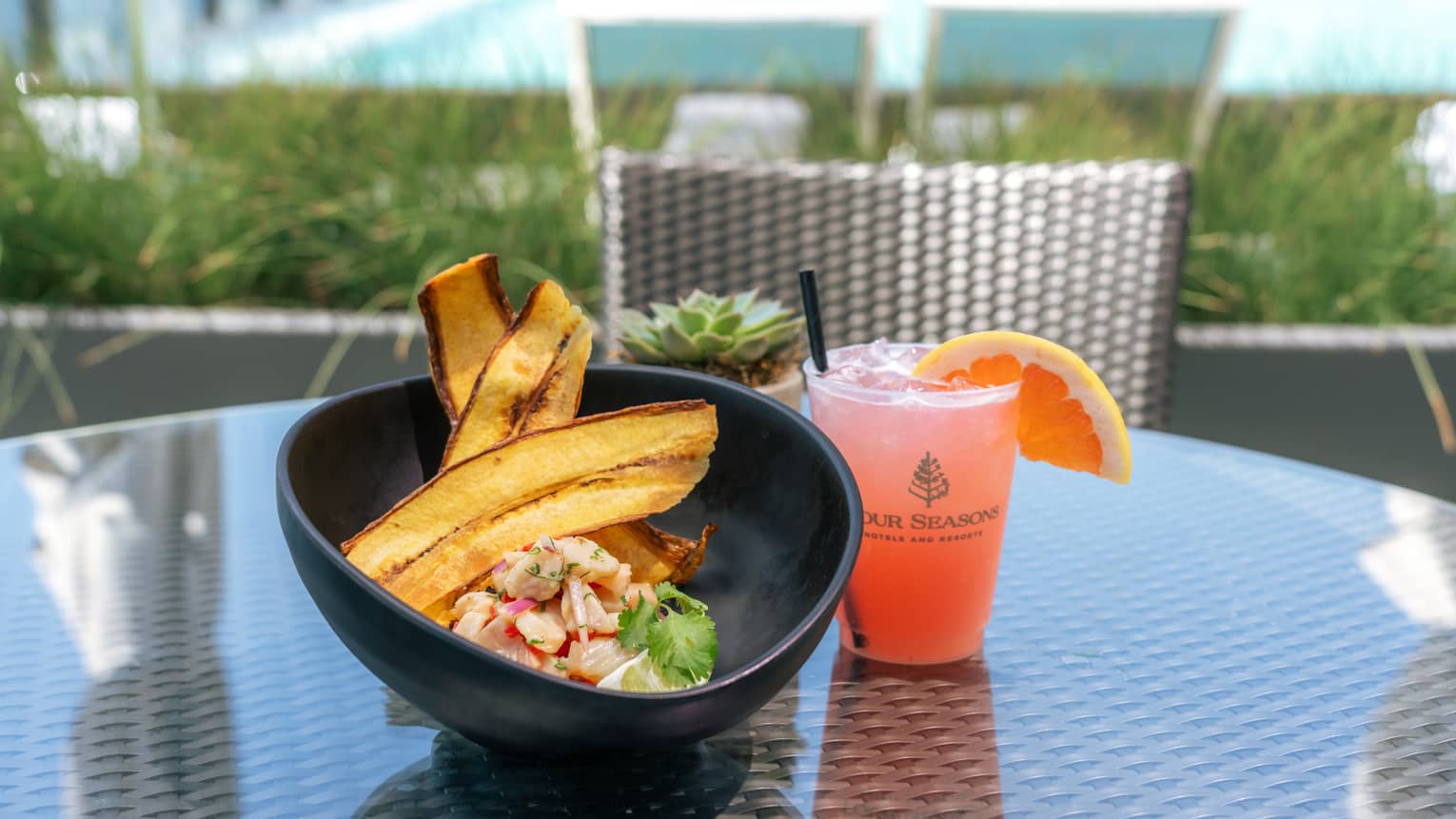 Mahi mahi with a pink drink with an orange slice on it.