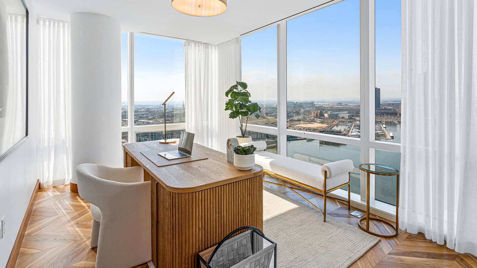 Interior office space with floor-to-ceiling windows and water views