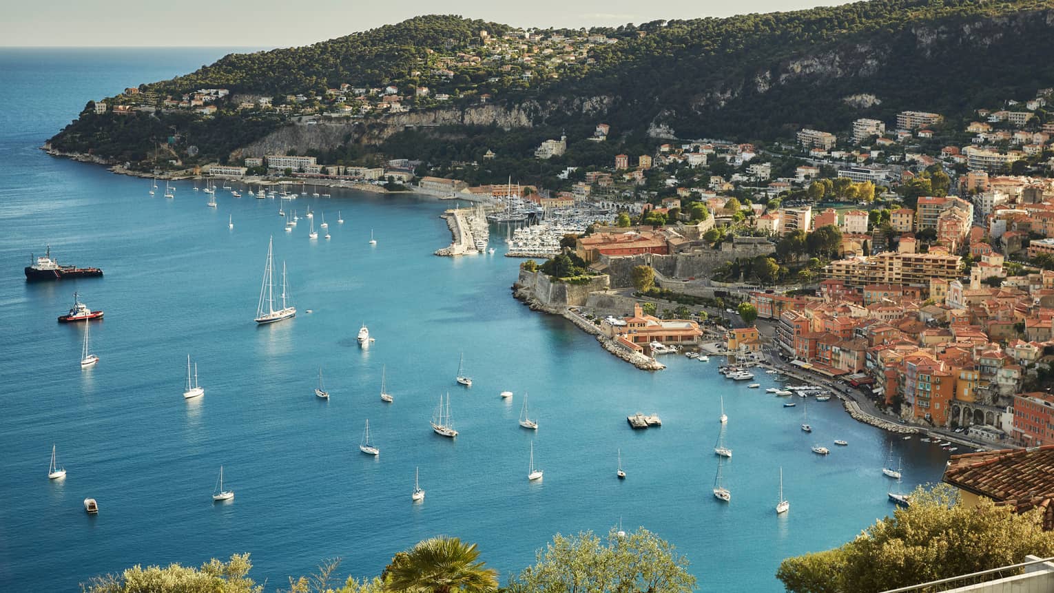 Aerial view of French Riviera waterfront, buildings along coast, yachts, boats in sea