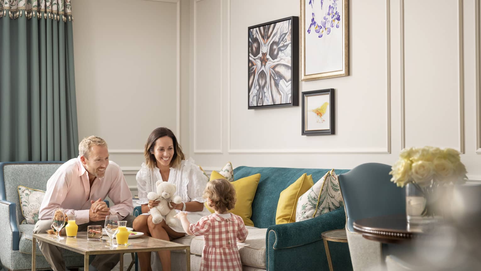 Family of three sitting in living room