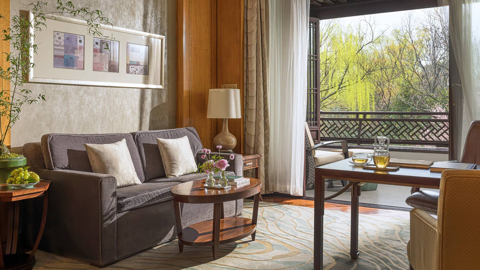 Sitting area of a hotel room, with sofa and coffee table
