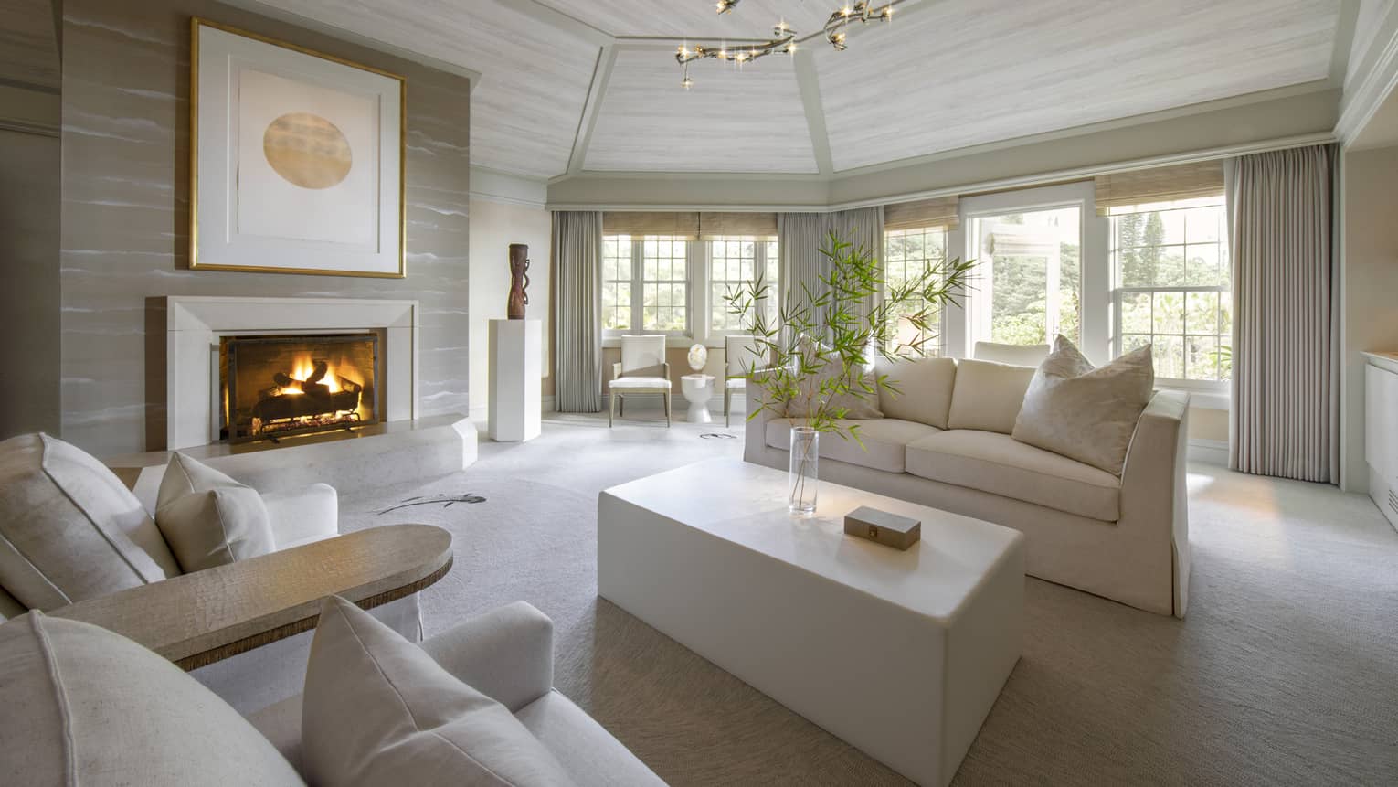 Guest suite living room with white couch and fireplace