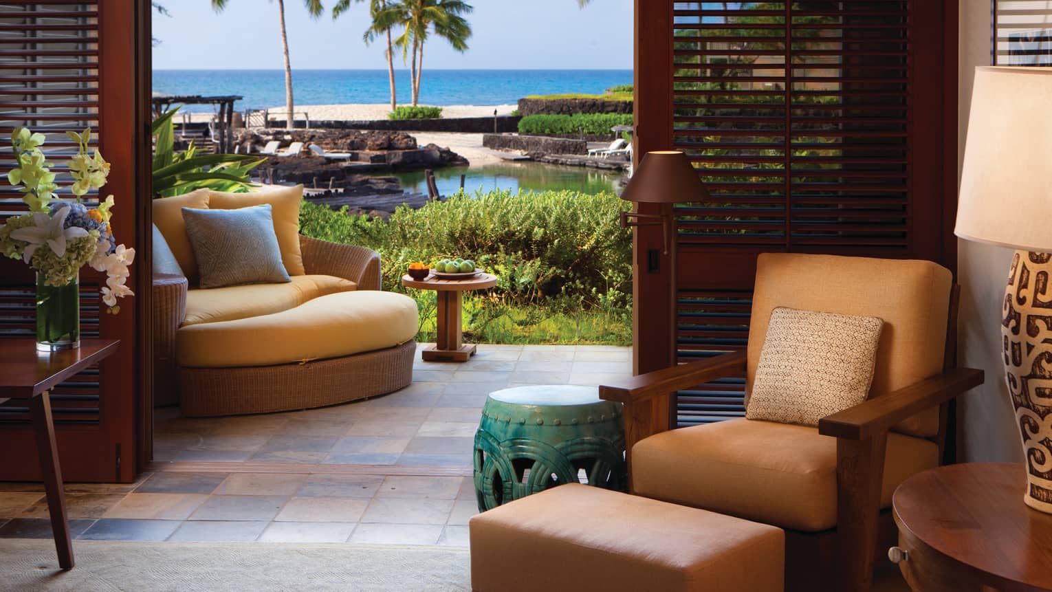 Superior Suite leather chair, green table by open patio door, wood shutters, large chair