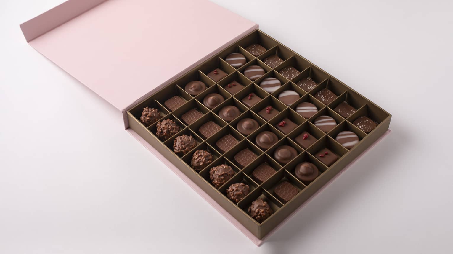 Large square pink box open to reveal 42 chocolate truffles,Large square pink box open to reveal 49 chocolate truffles