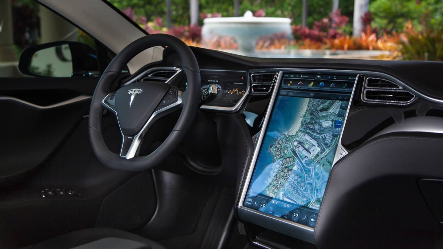 Close-up of Tesla car wheel, dashboard with touchscreen