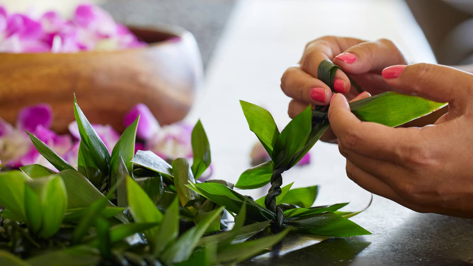 Guests weave leis out of fresh materials