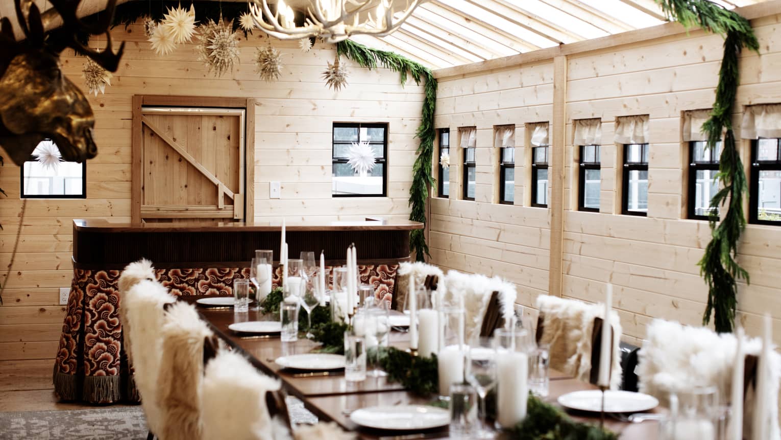 Dining room with fur chairs and garland decoration.