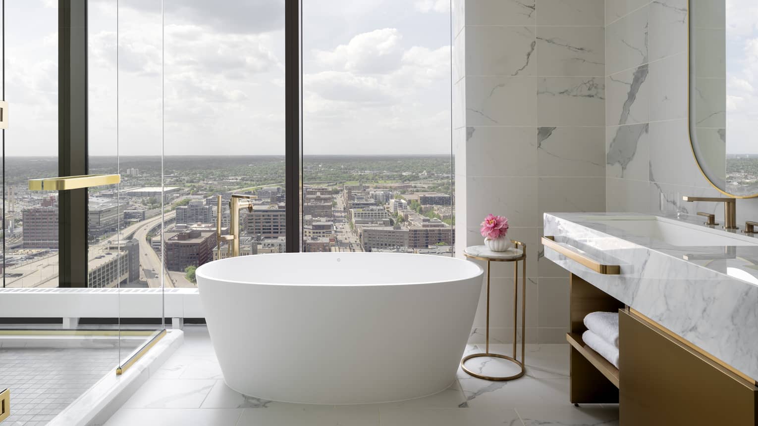 Bathroom with wall of windows and standalone tub