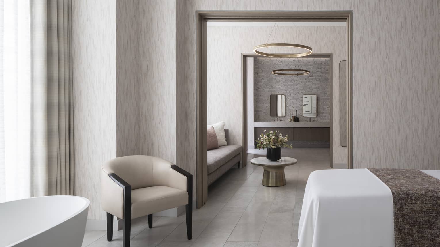 A spa treatment room with mid century modern furnishings, illuminated by natural light