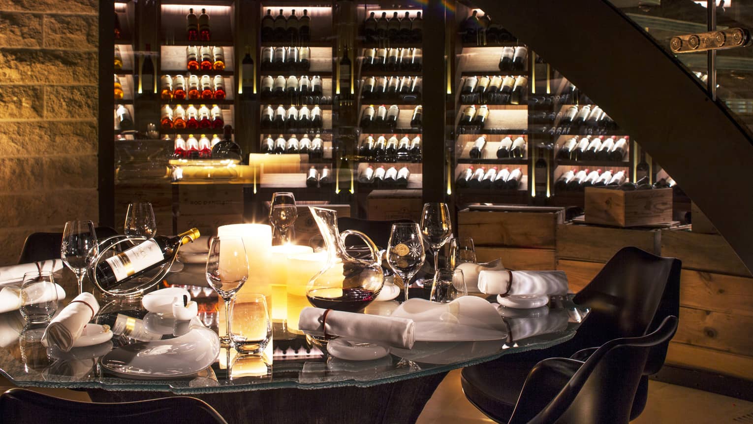 Wine Cellar dining table with bottles of wine, glasses, large candles