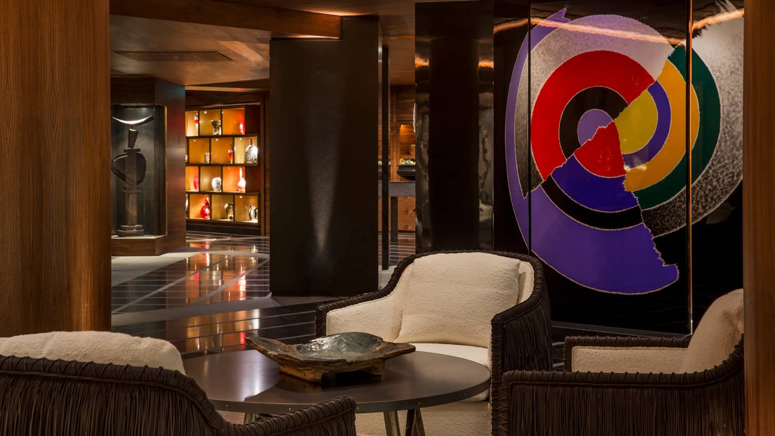 Lobby Lounge white chairs around cocktail table, large colourful modern art
