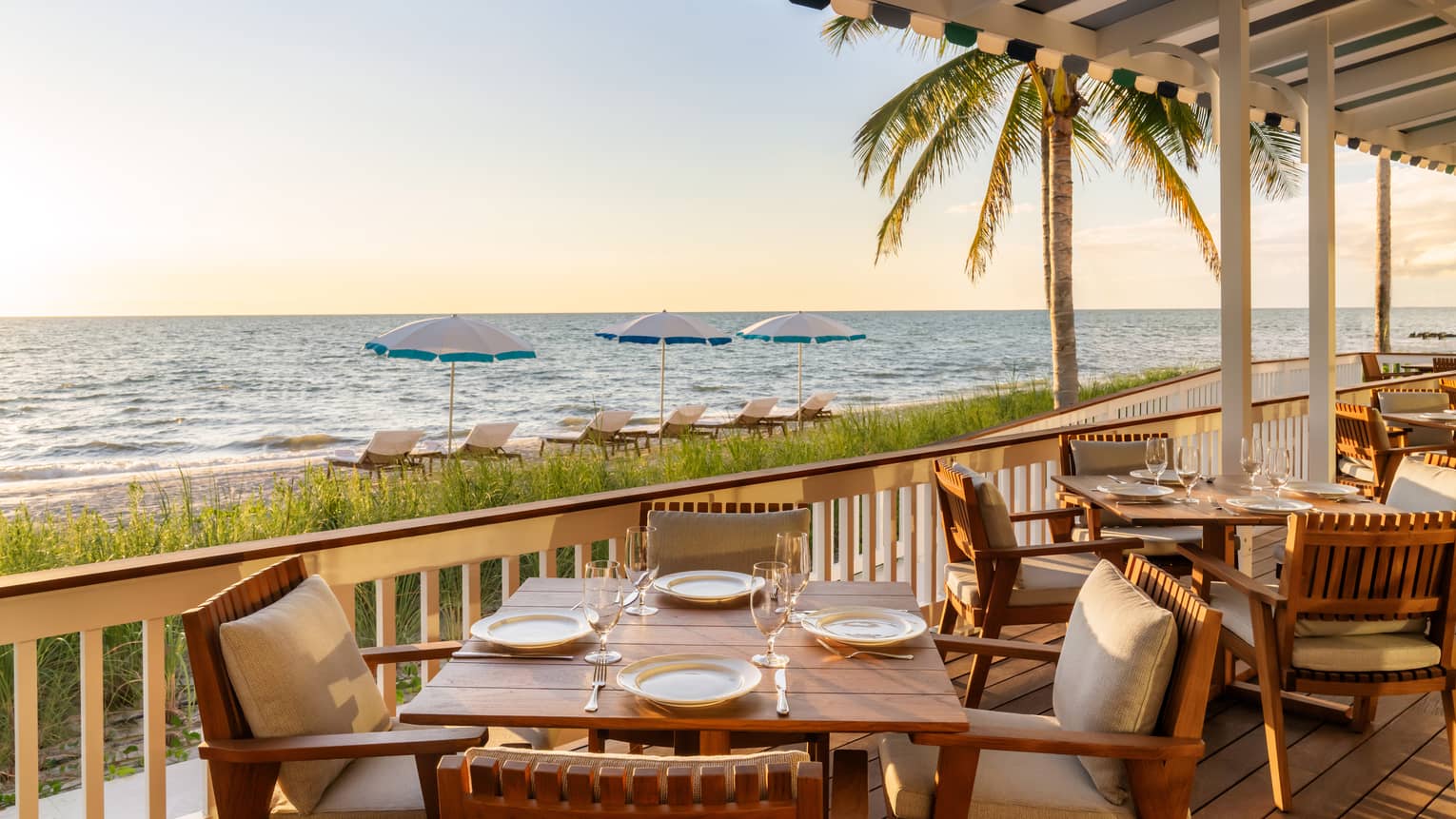 Restaurant terrace with tables overlooking the beach