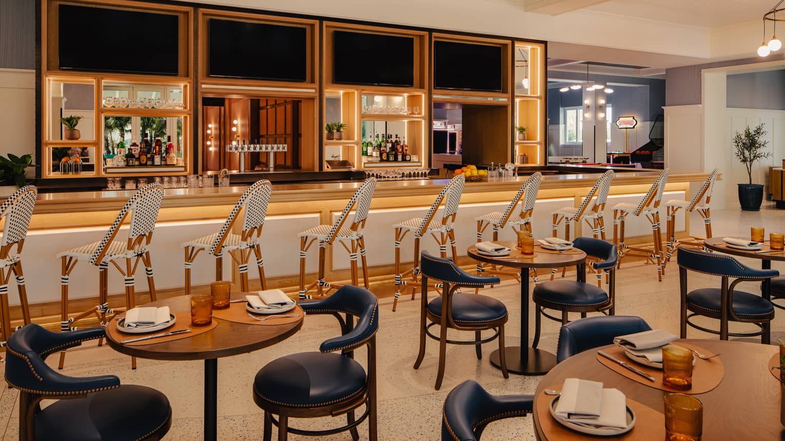 Restaurant dining room with bar counter and cocktail tables