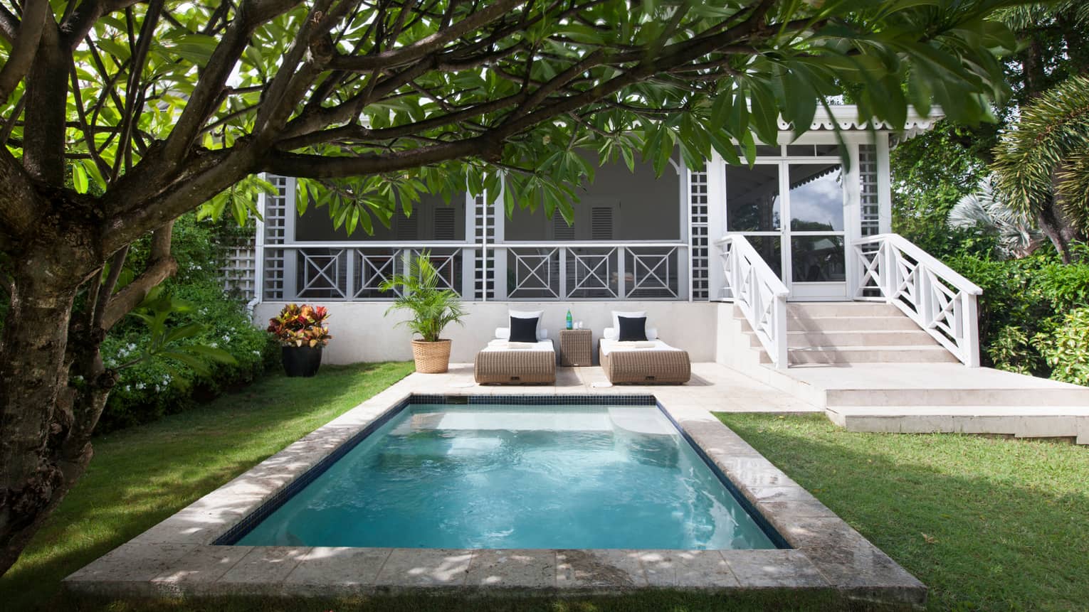 Palm Grove Villa residence with decorative white balcony, railings outdoor plunge swimming pool