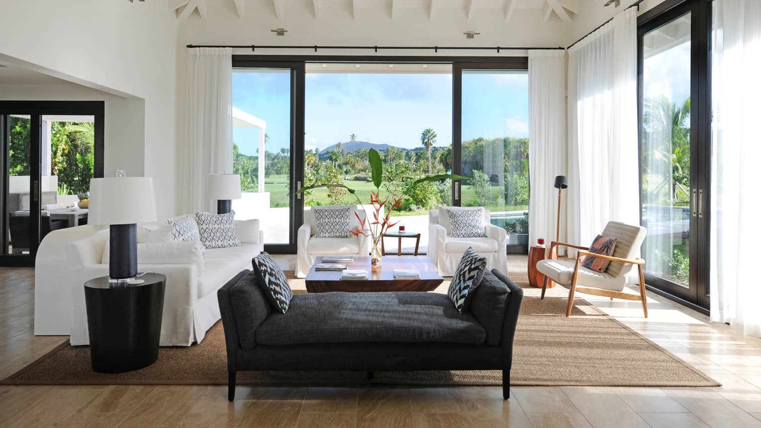 Pinney's Beach Residence Villa black chaise, white sofas, large glass patio door