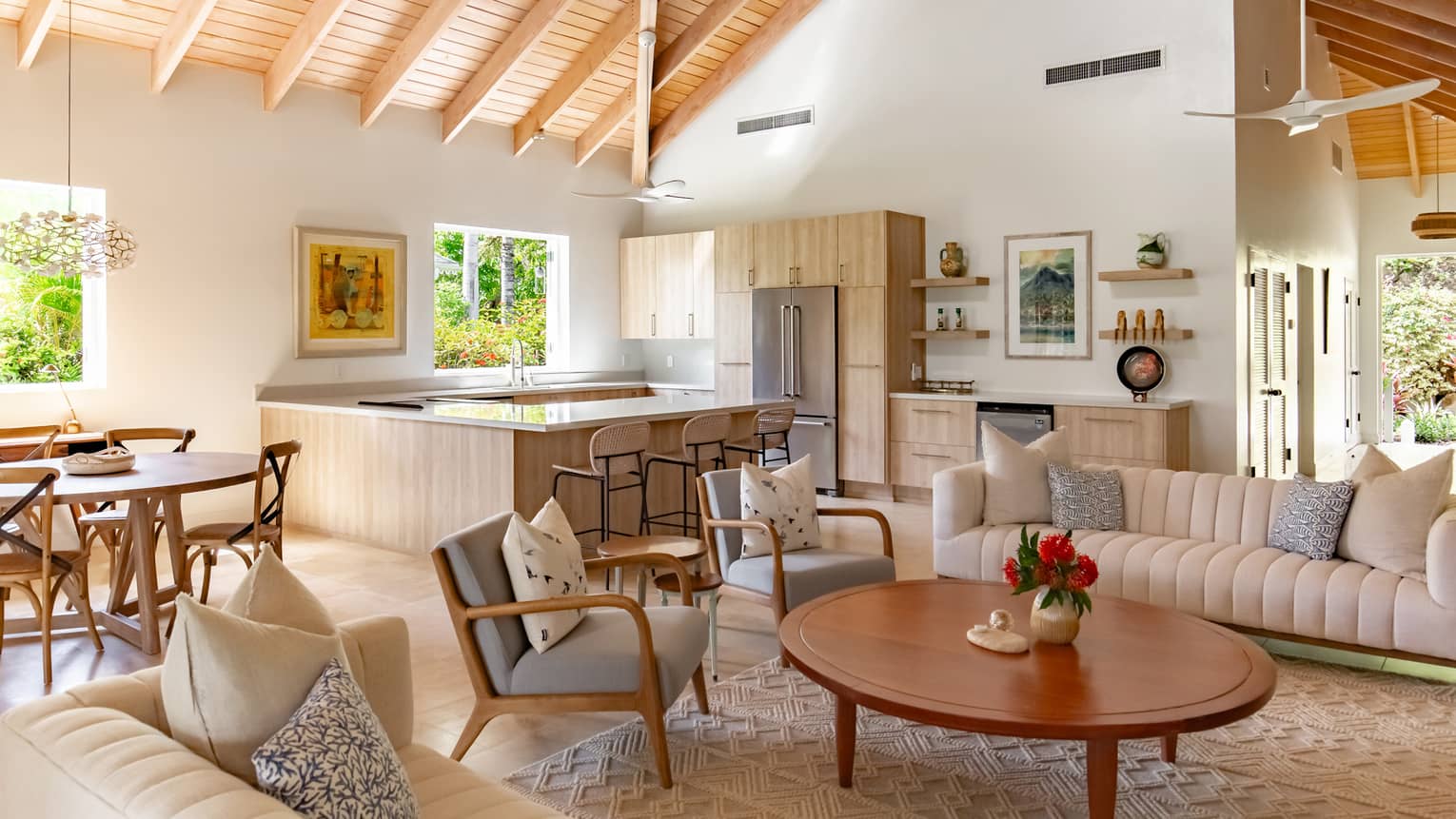 A kitchen and living room area with wooden cabinets and ceiling