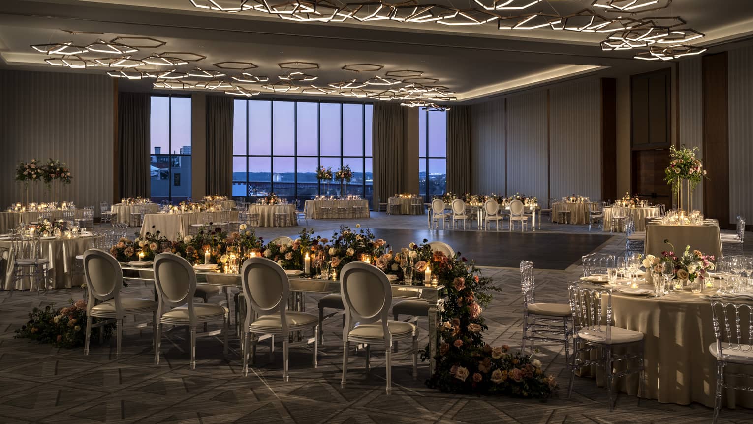 Ballroom with flowers and candles on every table.