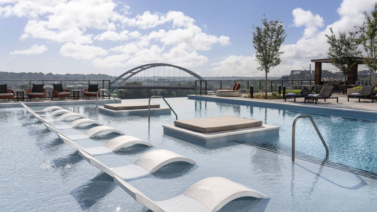An outdoor pool with lounge chairs.