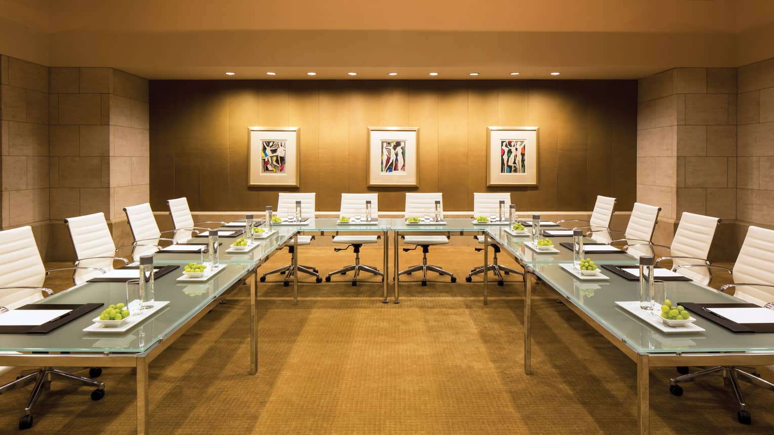 Metropolitan Suite meeting room with large modular glass boardroom tables, white leather chairs