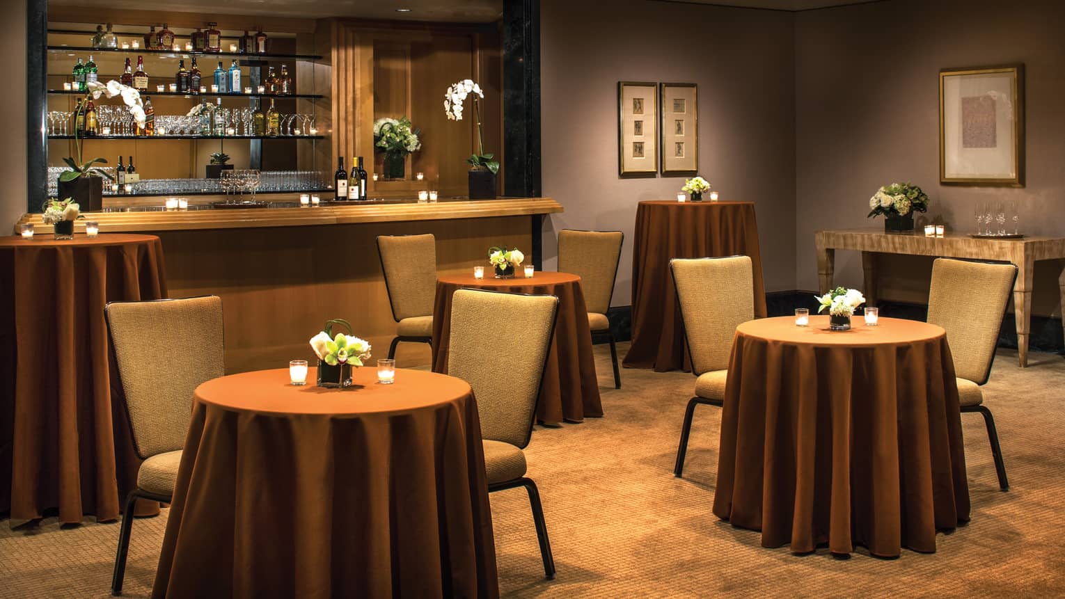 Salon Foyer with small cocktail tables and chairs in front of event bar 