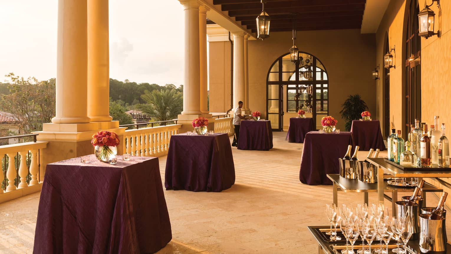 Sunny Grand Ballroom West Terrace with cocktail tables, wine station under pillars