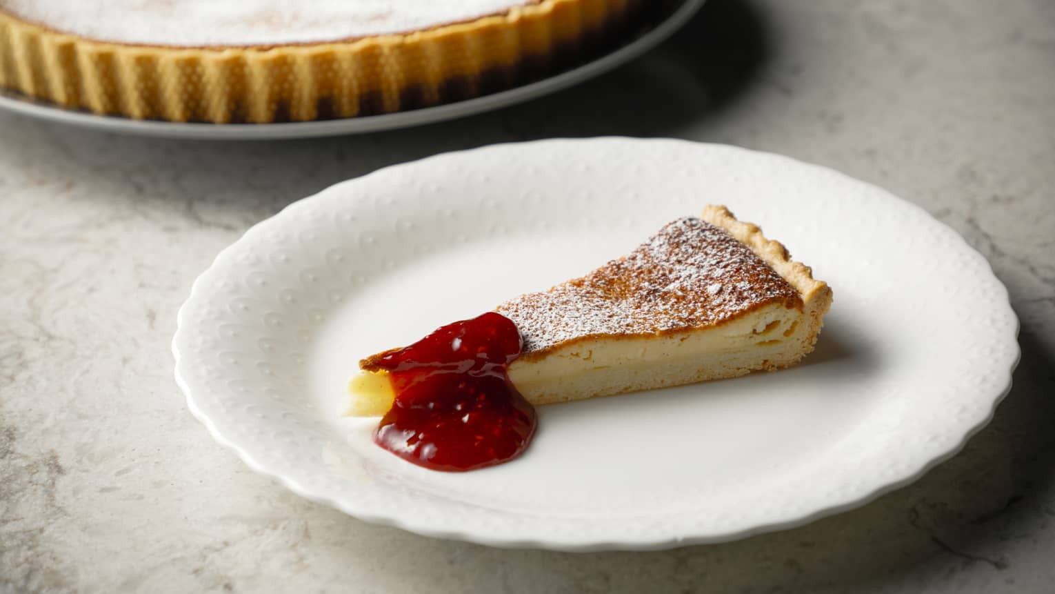Baked cheesecake slice with raspberry compote