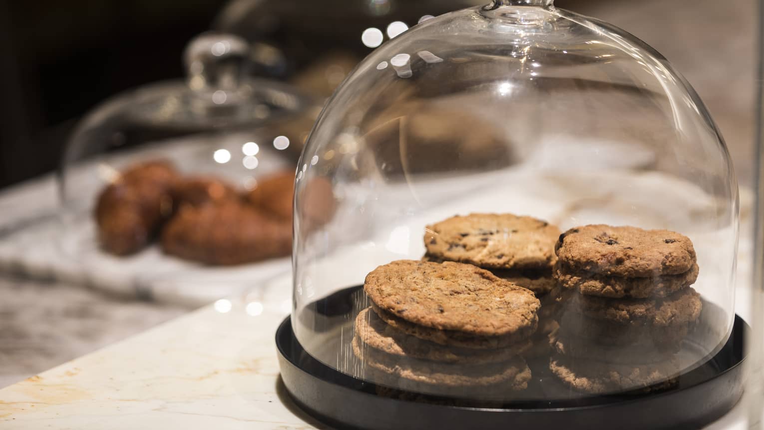 Cookies under a glass cover.