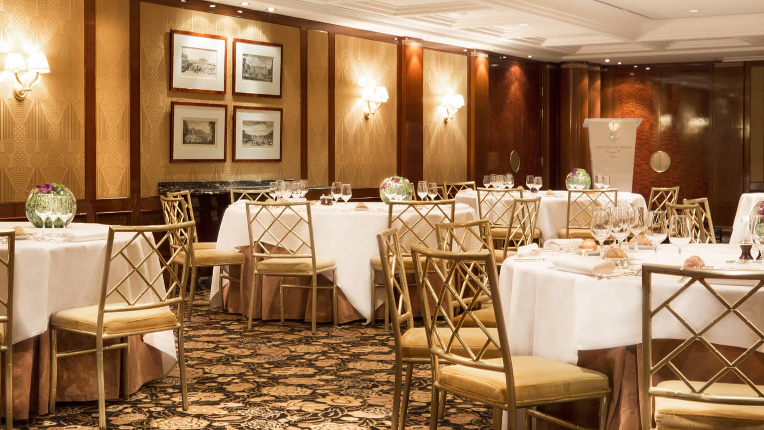 Salon Chantilly banquet dining tables and chairs, panel walls with lights, framed prints